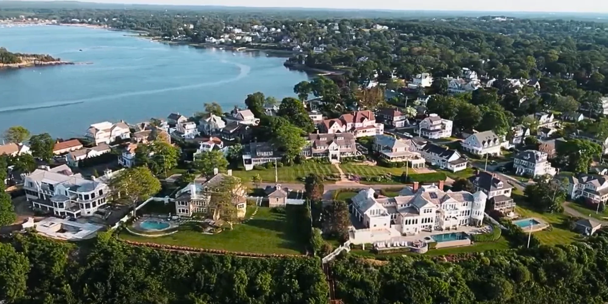 Beautifully painted coastal home in Cape Cod at dusk, featuring manicured landscaping and hydrangeas.