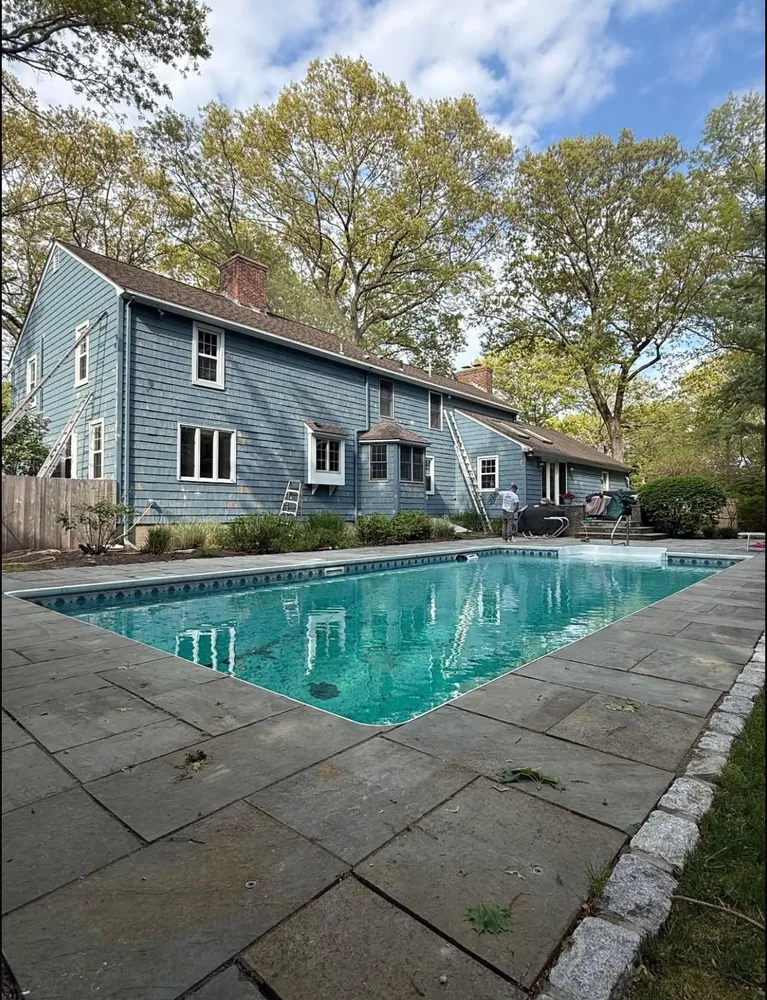 Blue shingle home exterior during preparation, before painting