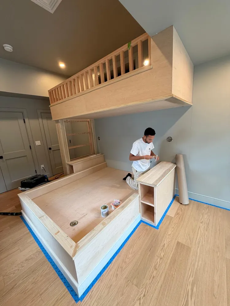 Custom built-in loft bed in raw wood before finishing