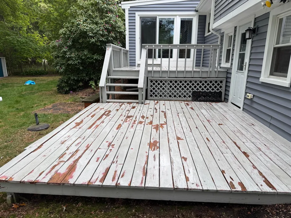 Weathered deck with peeling paint before restoration