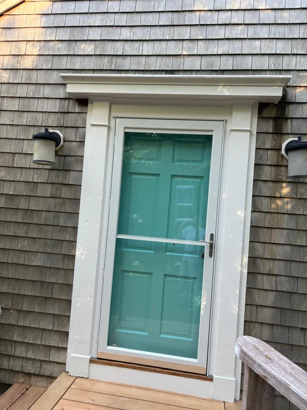 Old faded gray deck boards being restored to a rich brown color with stain application