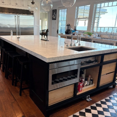 Crisp teal painted exterior door against traditional Cape Cod wood shingle siding
