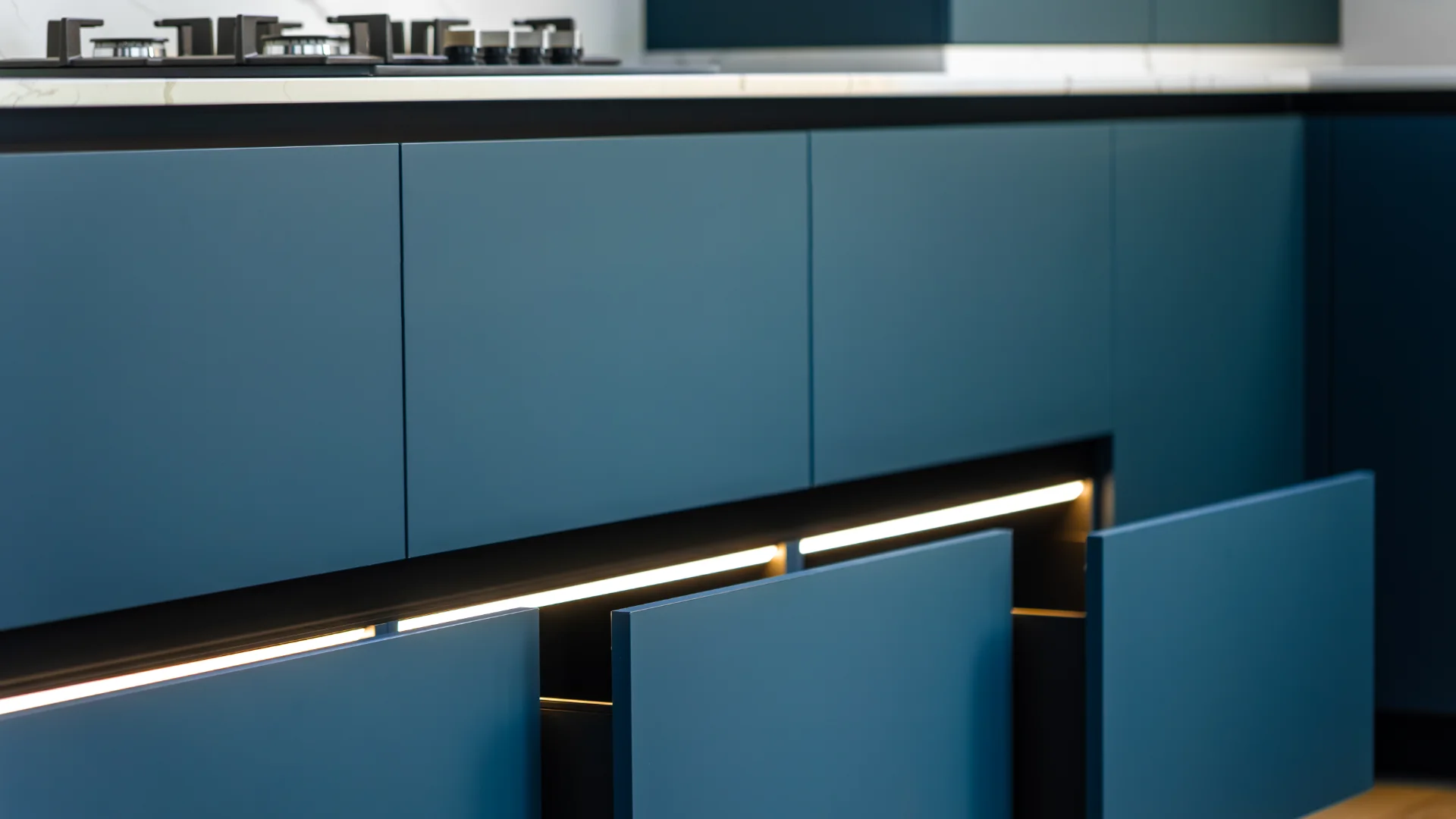 Close-up of premium modern blue kitchen cabinets with custom lighting and sleek finish
